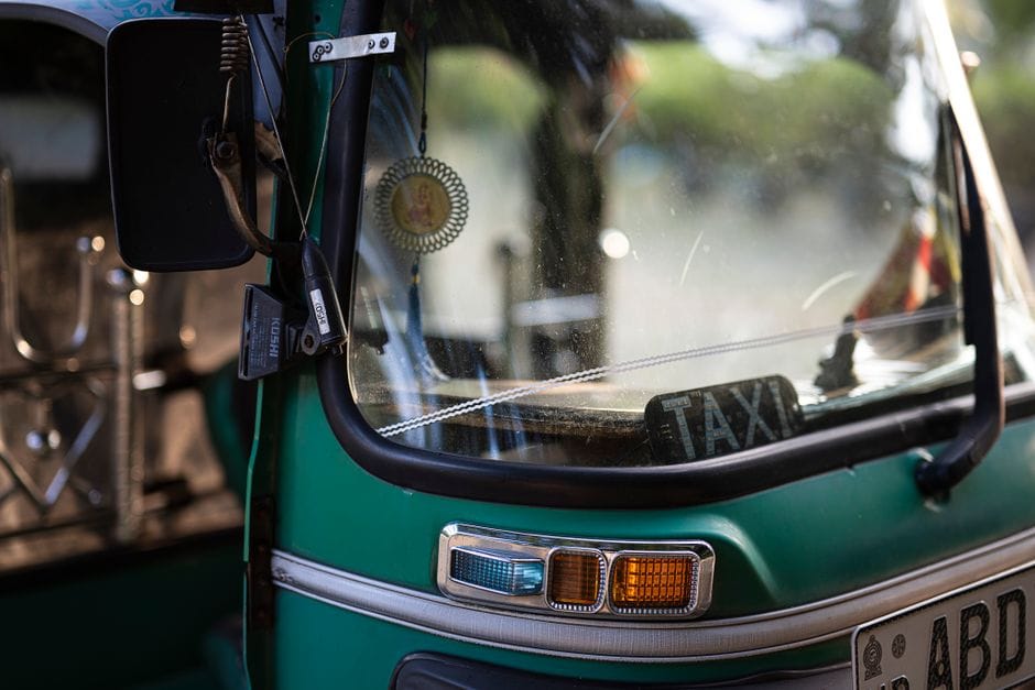 Green tuk-tuk taxi close-up showing windshield and details in Colombo, Sri Lanka.