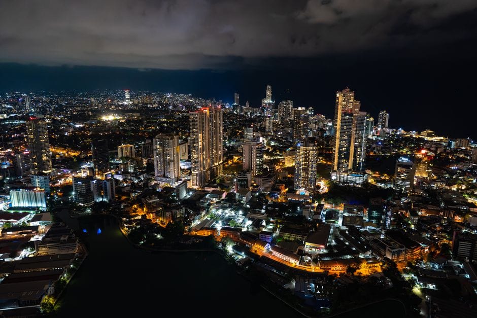 A captivating aerial view of Colombo's cityscape at night, showcasing its vibrant lights and towering skyscrapers.