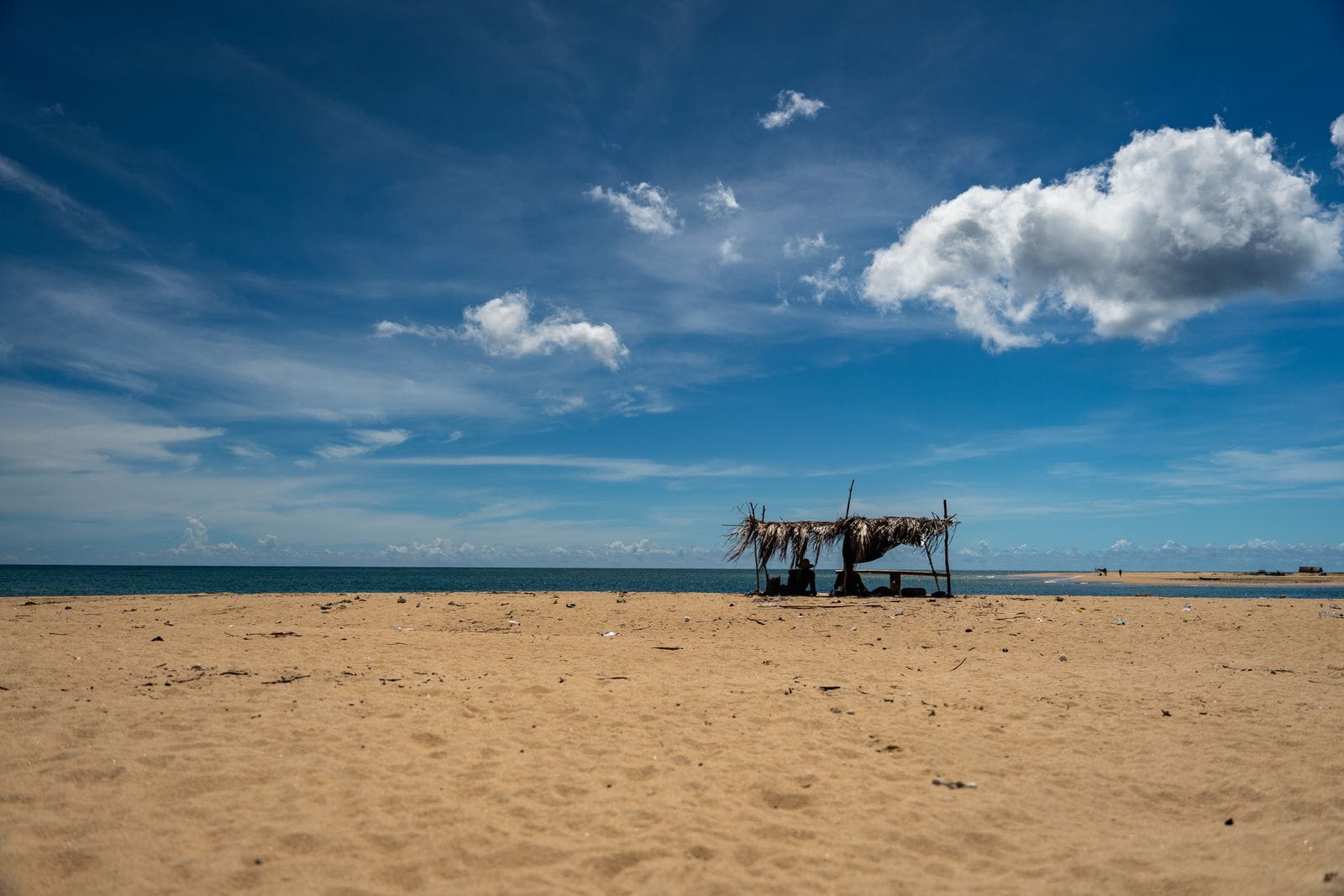 A rustic beach shelter under a blue sky on Sri Lanka's east coast