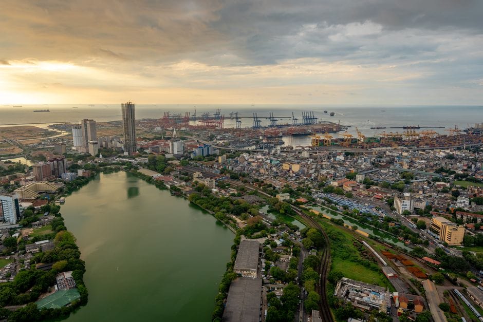 Aerial view of Colombo's skyline, port, and lake at sunset in Sri Lanka.