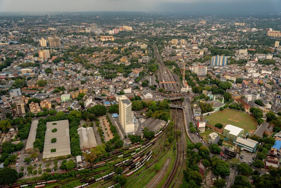 Stunning aerial cityscape of Colombo, showcasing urban sprawl and railway tracks.